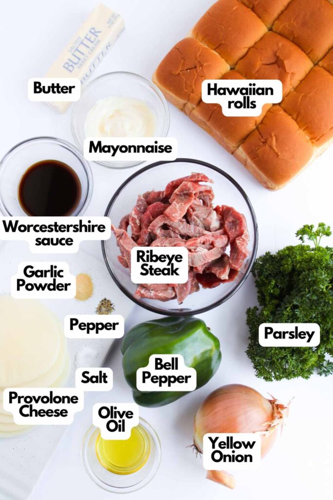 Ingredients for Philly Cheesesteak Sliders: ribeye steak, Hawaiian rolls, butter, mayonnaise, Worcestershire sauce, garlic powder, pepper, salt, bell pepper, yellow onion, provolone cheese, olive oil, parsley. Enjoy the classic flavors in a compact slider form.