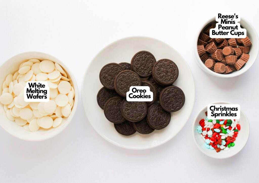 Four bowls containing white melting wafers, Oreo cookies for Oreo Christmas Ornament Cookies, Reese&rsquo;s Minis peanut butter cups, and Christmas sprinkles, each labeled with text.
