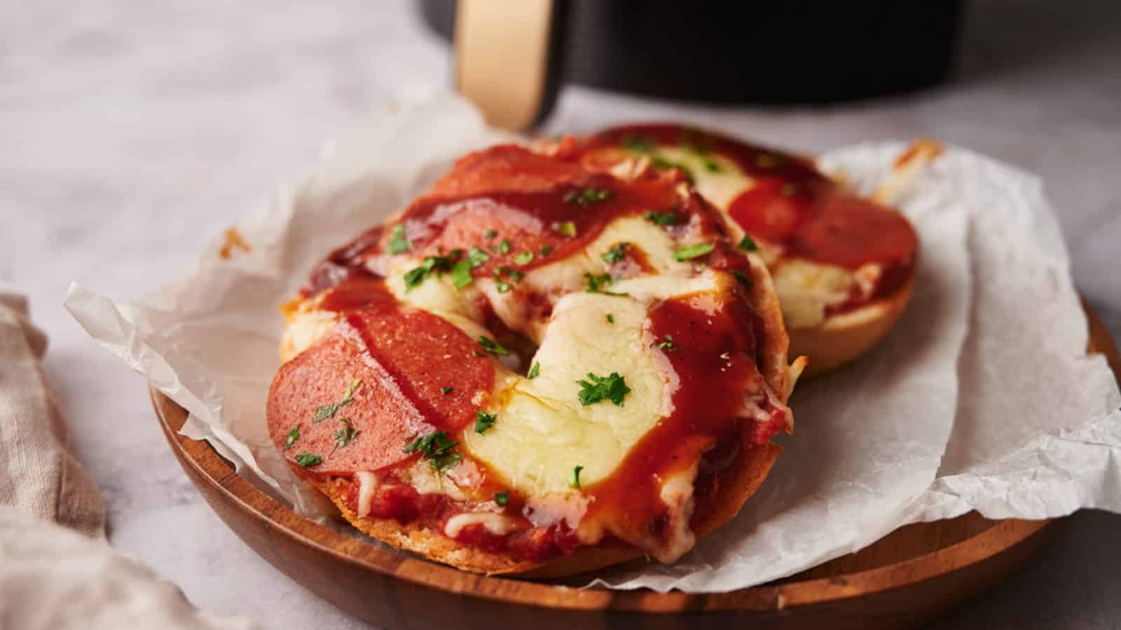 A pizza bagel with bbq sauce and parsley.