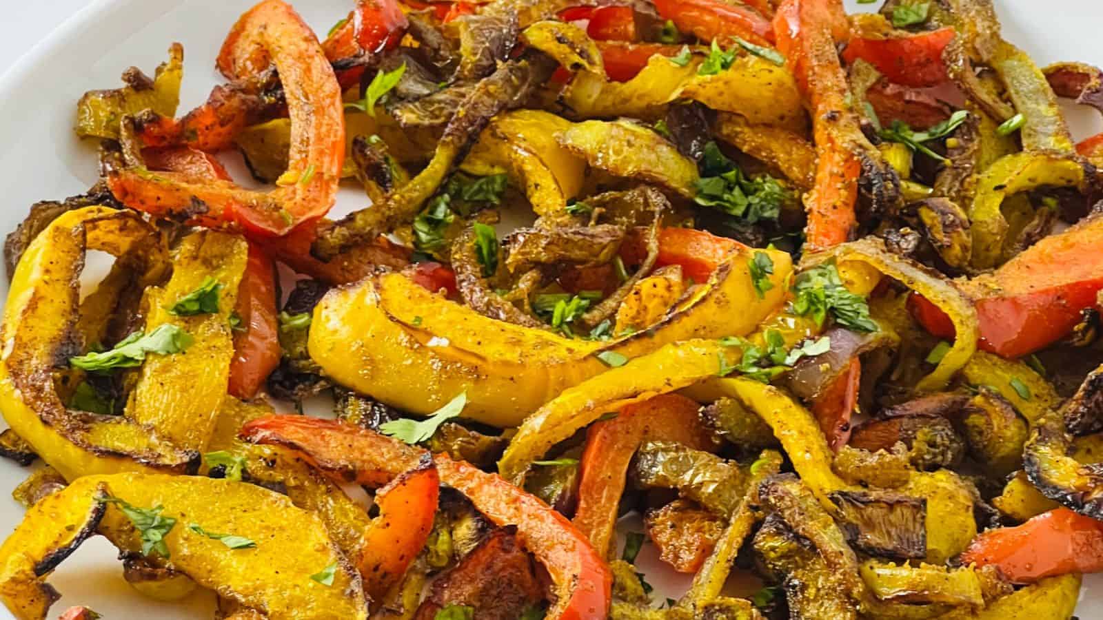 A plate of saut&eacute;ed colorful bell peppers seasoned with herbs and spices.