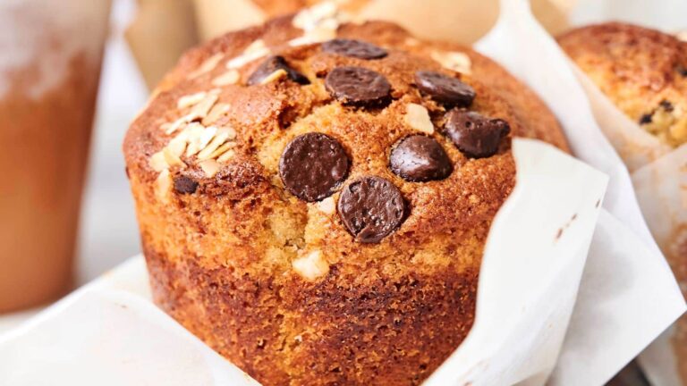 Close-up of a muffin topped with chocolate chips and oats.