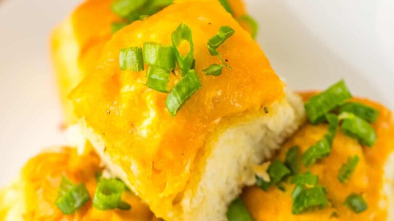 Close-up of cheesy bread topped with chopped green onions.