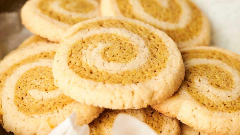 A close-up of several spiral cookies with a light brown and white swirled pattern.