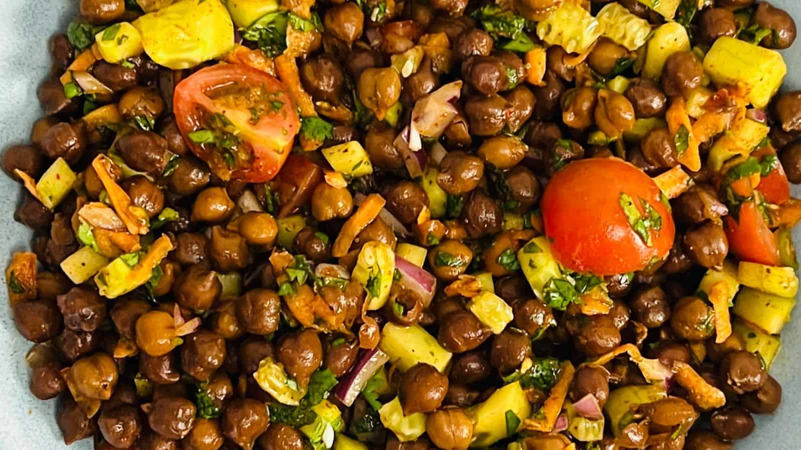 Kala chana chaat served in a blue bowl.