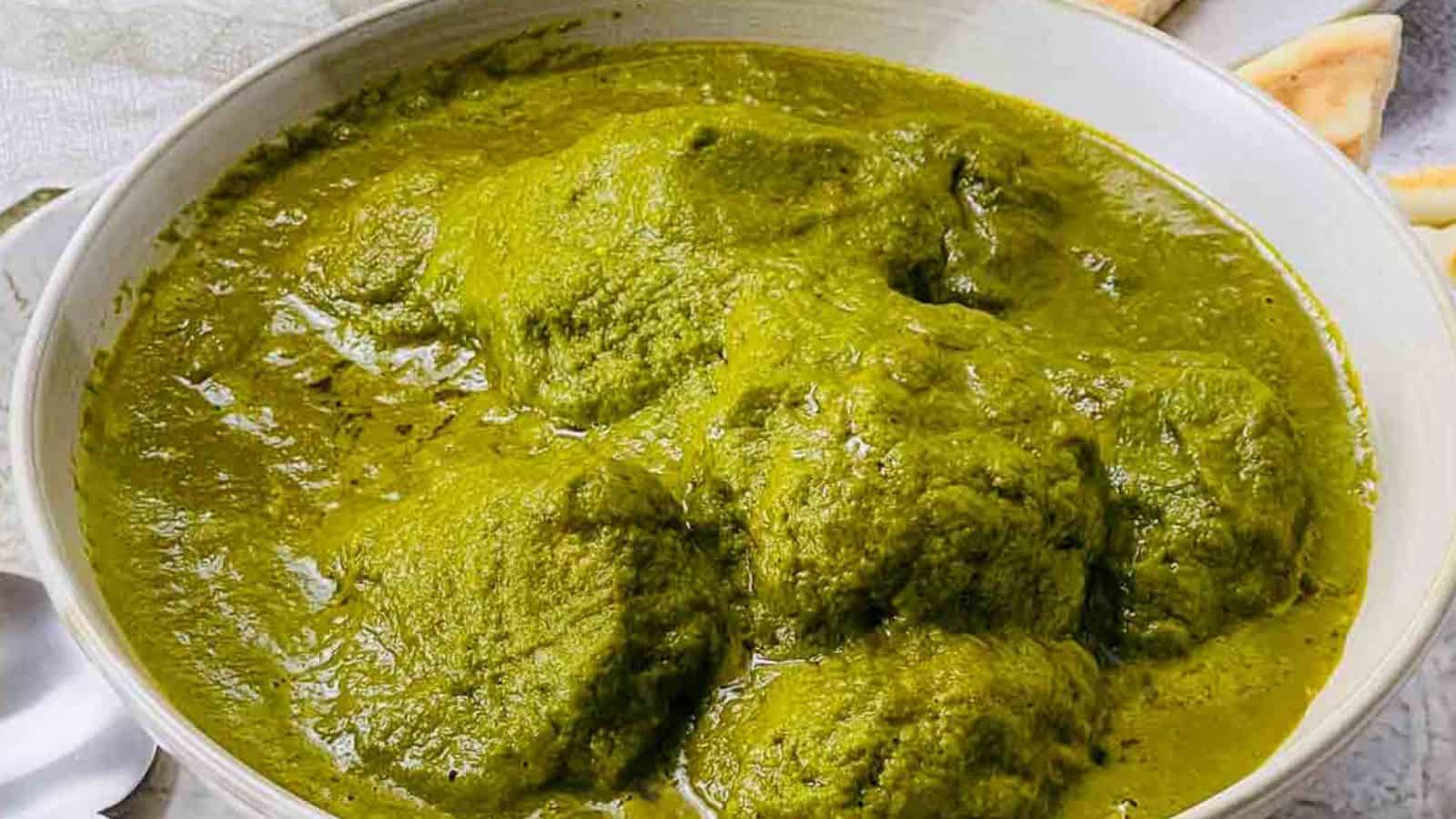 Lamb and spinach curry served with naan.