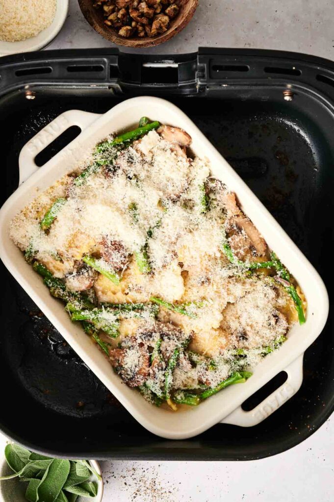 A delightful Air Fryer Ravioli Casserole combines asparagus, mushrooms, and chicken under a crisp breadcrumb topping, perfectly suited for an air fryer basket.
