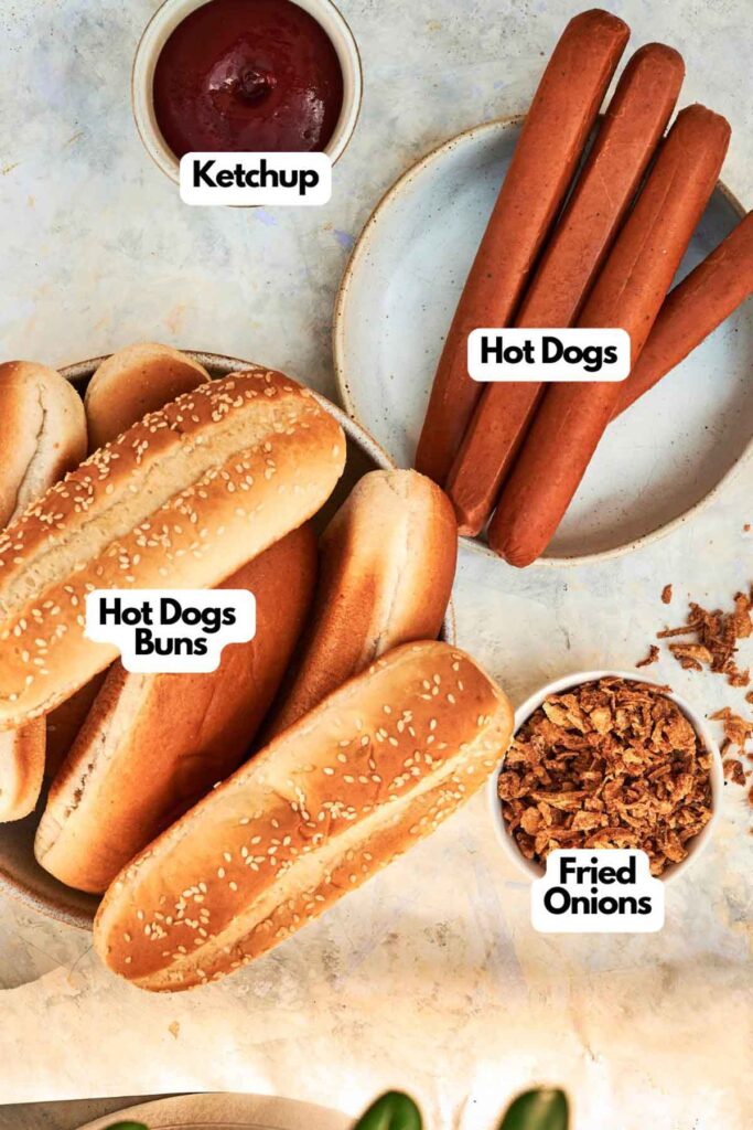 Top-down view of Grilled Hot Dogs, hot dog buns, ketchup, and a bowl of fried onions, each clearly labeled.