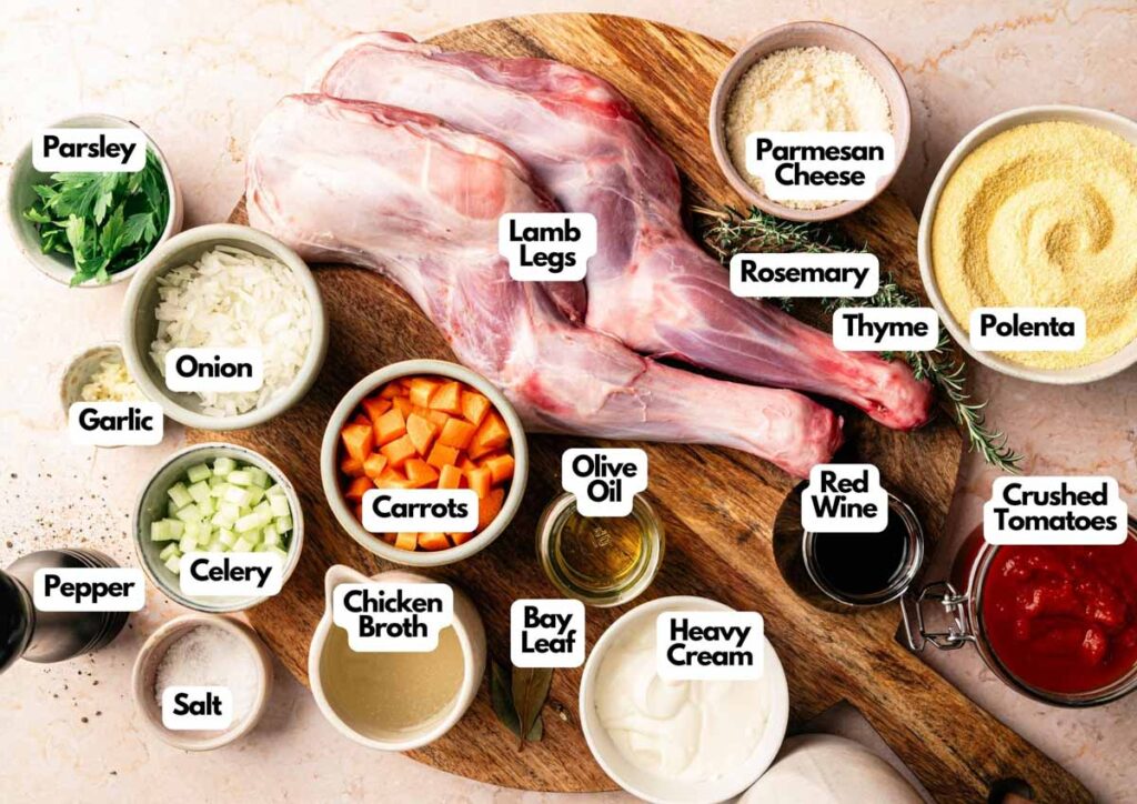 Ingredients for Mediterranean Lamb Shank with Polenta are arranged on a wooden board, including lamb legs, vegetables, herbs, cheese, polenta, broth, cream, wine, and seasonings—each carefully labeled.